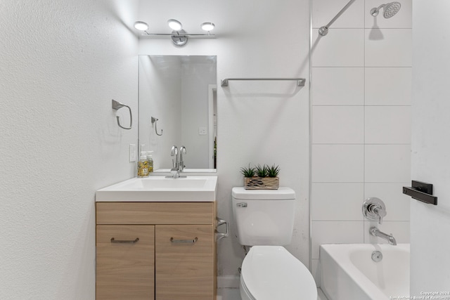 full bathroom with vanity, toilet, and tiled shower / bath