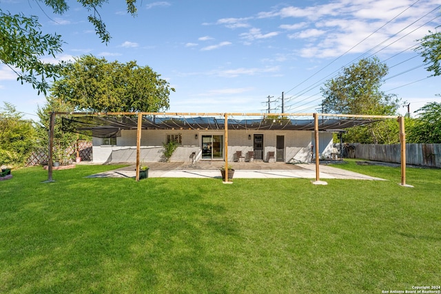 back of property with a patio area and a yard