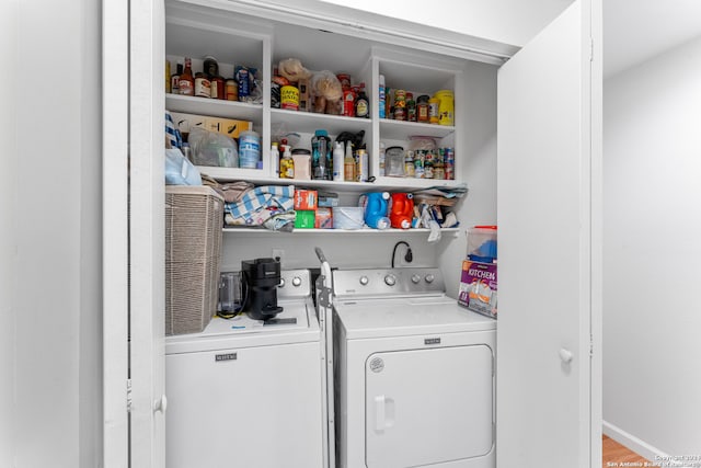 laundry room with hardwood / wood-style flooring and separate washer and dryer