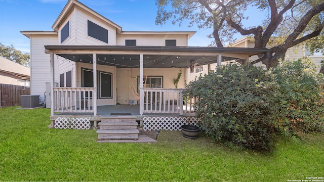 rear view of house featuring ceiling fan, a yard, a patio, and central AC