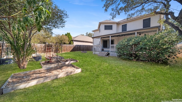 rear view of property featuring a yard