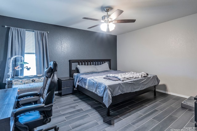 bedroom with ceiling fan and dark hardwood / wood-style flooring