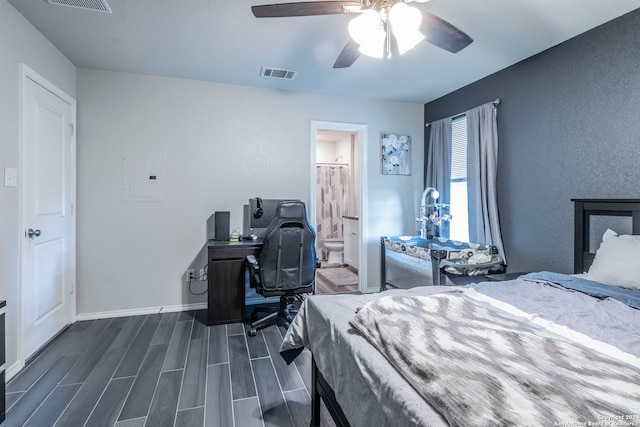 bedroom featuring dark hardwood / wood-style floors, ceiling fan, ensuite bathroom, and electric panel