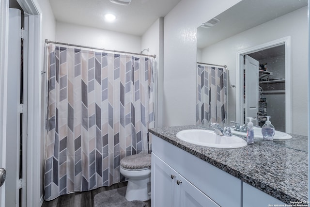 bathroom featuring vanity, wood-type flooring, a shower with curtain, tile walls, and toilet