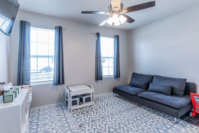 living room with a healthy amount of sunlight and ceiling fan