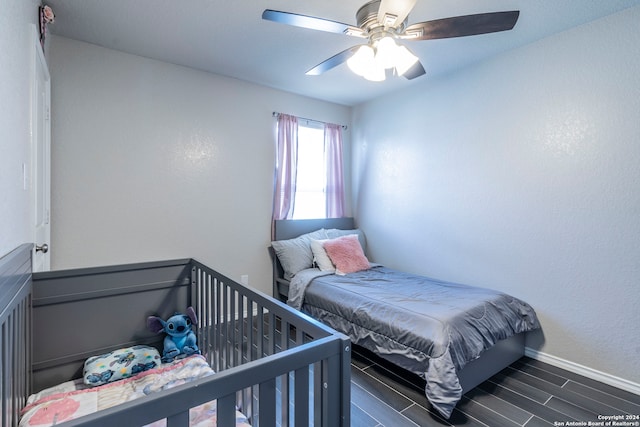 bedroom with ceiling fan and dark hardwood / wood-style floors