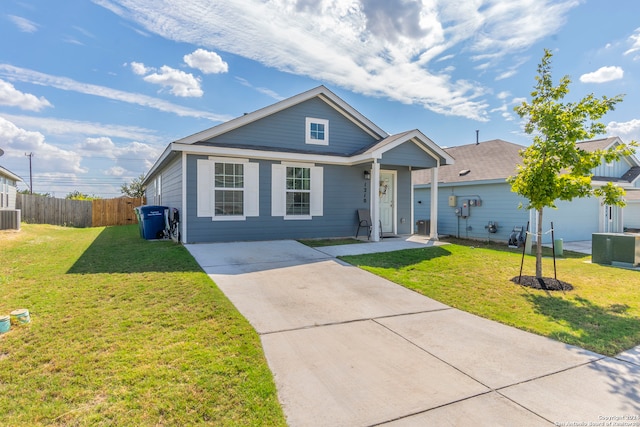 view of front of house with a front yard, central air condition unit, and a garage