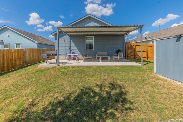 rear view of house featuring a lawn and a patio area