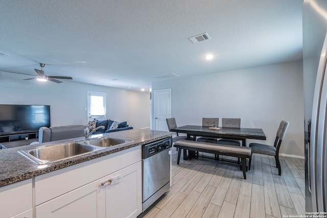 kitchen with ceiling fan, white cabinets, sink, light hardwood / wood-style flooring, and dishwasher