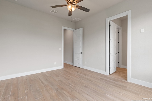 unfurnished bedroom with ceiling fan and light wood-type flooring