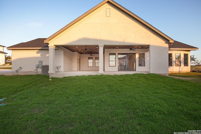 back of house featuring ceiling fan, a yard, a patio, and central air condition unit