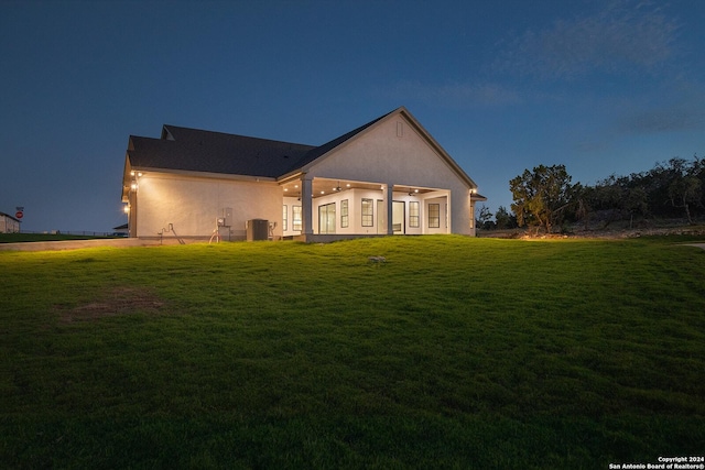 back of property with a yard and cooling unit