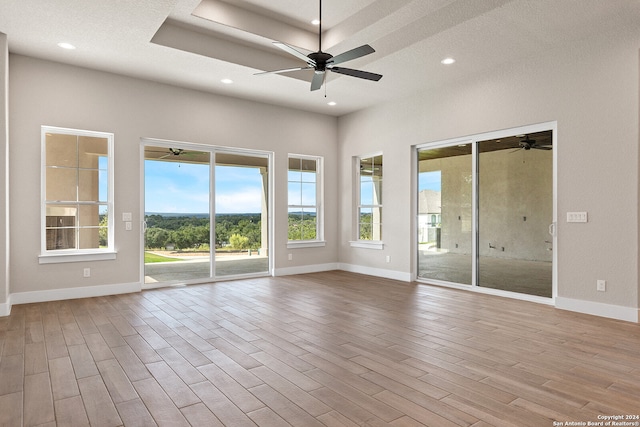 spare room with a textured ceiling and light hardwood / wood-style floors