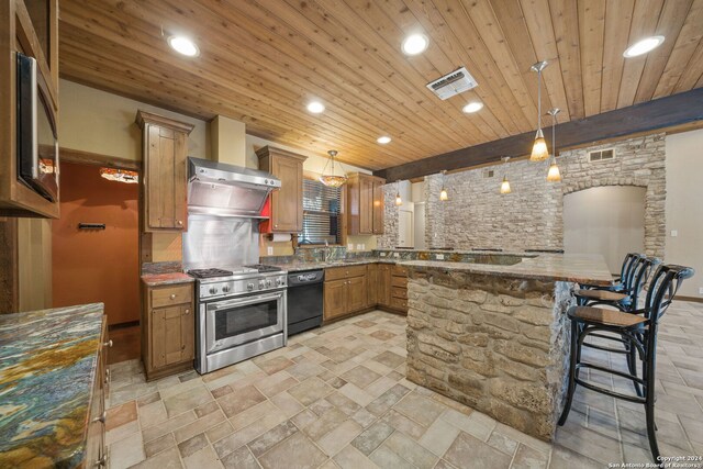 kitchen featuring stainless steel stove, black dishwasher, hanging light fixtures, and a kitchen bar