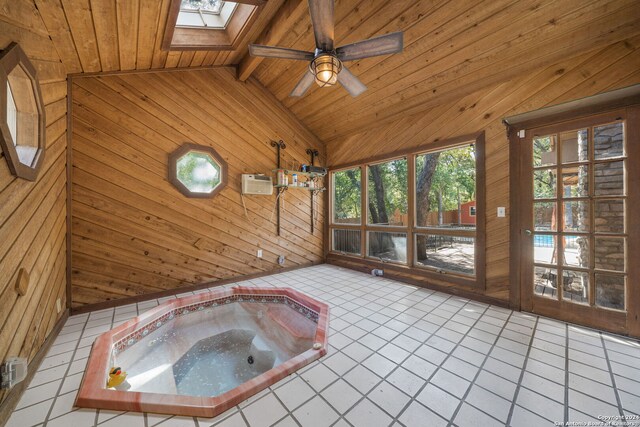 unfurnished sunroom featuring wooden ceiling, vaulted ceiling with skylight, a hot tub, and a wall mounted air conditioner