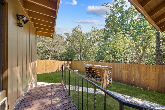 wooden terrace with a yard