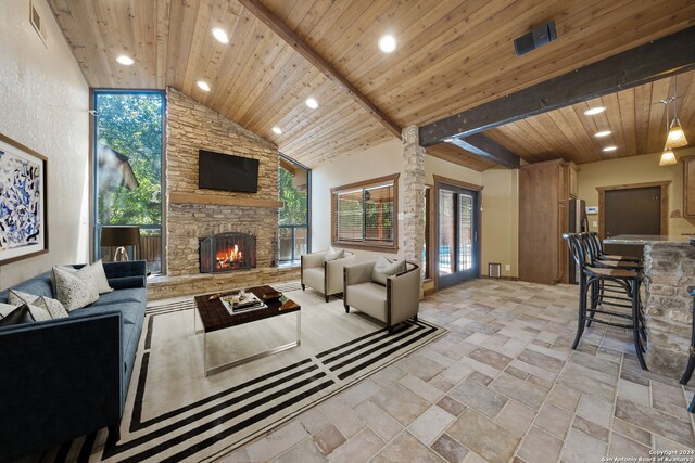 living room with wooden ceiling, a fireplace, beam ceiling, and high vaulted ceiling