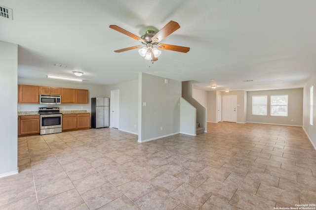 kitchen featuring ceiling fan and stainless steel appliances