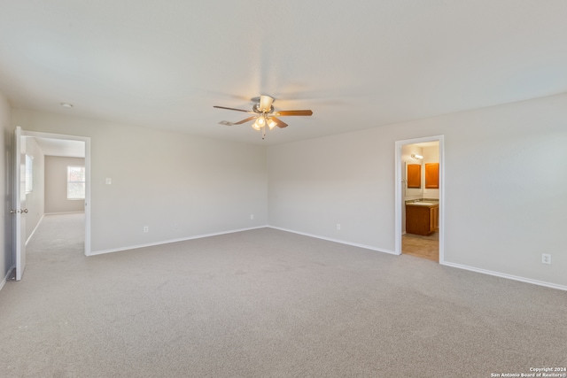 unfurnished room with ceiling fan and light colored carpet