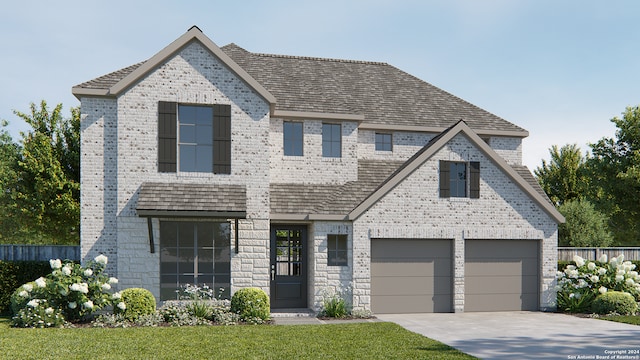 view of front facade with a garage and a front lawn