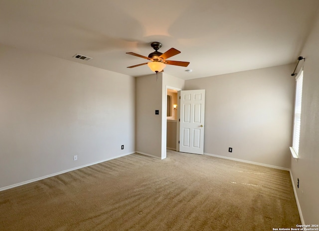 carpeted empty room featuring ceiling fan