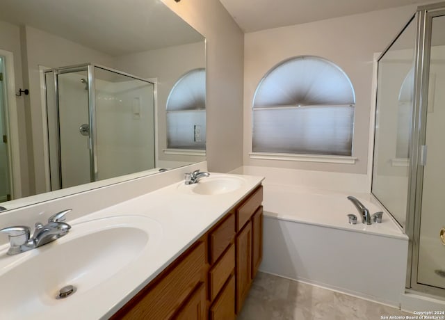 bathroom with shower with separate bathtub and vanity