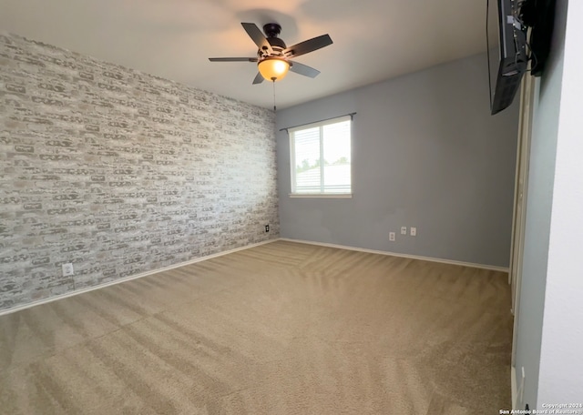 empty room with ceiling fan and carpet floors