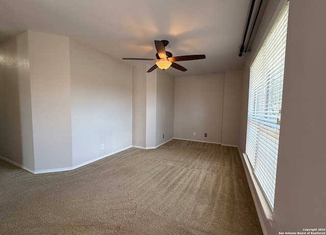 empty room with ceiling fan and carpet floors