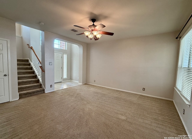 unfurnished living room with ceiling fan and light carpet