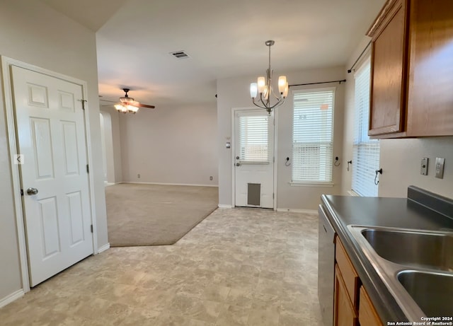 kitchen featuring dishwasher, sink, ceiling fan with notable chandelier, light colored carpet, and hanging light fixtures