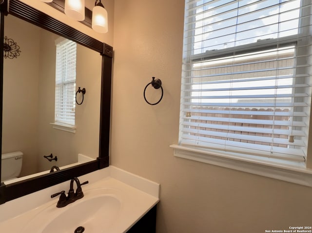 bathroom featuring vanity and toilet