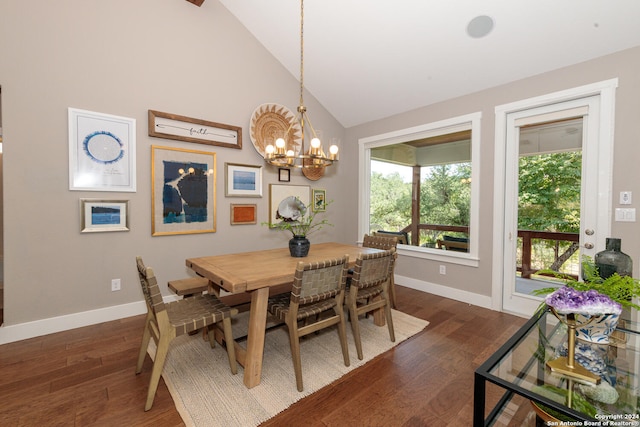 dining area with dark wood-type flooring, high vaulted ceiling, and a chandelier