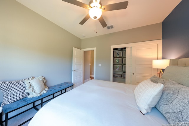 bedroom featuring ceiling fan, a closet, and lofted ceiling