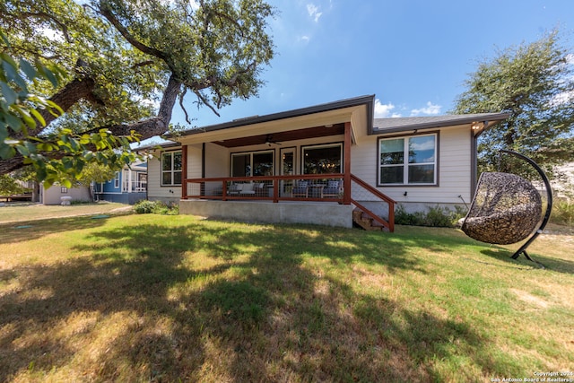 back of property featuring a porch, a yard, and ceiling fan