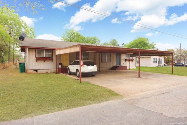 ranch-style house featuring a carport and a front yard