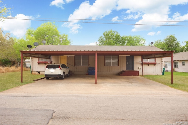 single story home featuring a carport and a front yard