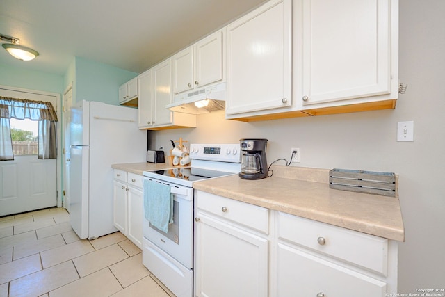 kitchen with light tile patterned flooring, white appliances, and white cabinetry