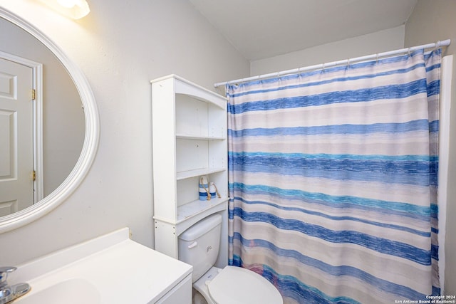 bathroom featuring walk in shower, vanity, lofted ceiling, and toilet