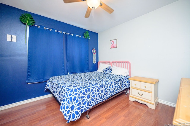 bedroom with wood-type flooring and ceiling fan