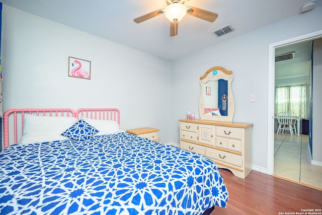 bedroom featuring ceiling fan and dark hardwood / wood-style flooring