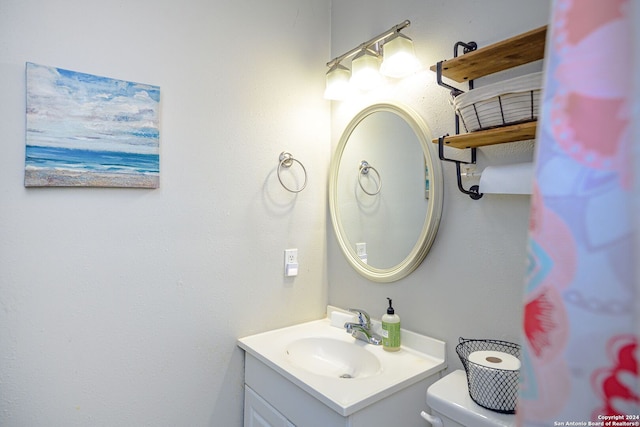 bathroom featuring vanity and toilet