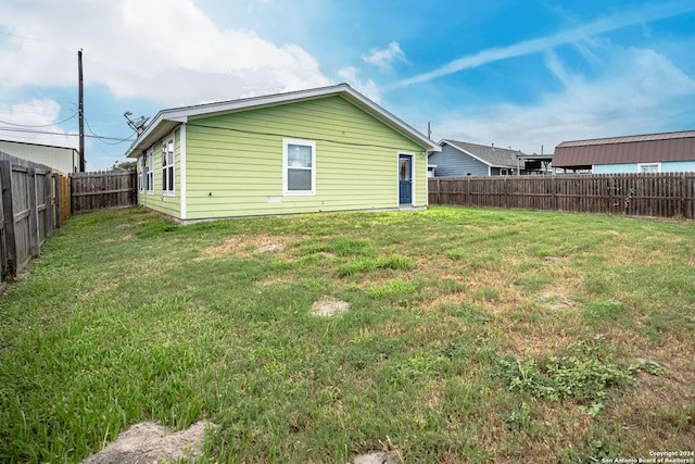 rear view of property with a lawn