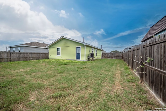 back of property featuring a yard