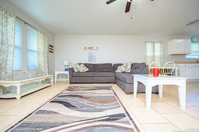 tiled living room featuring ceiling fan