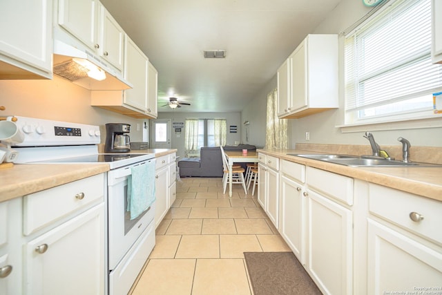 kitchen featuring ceiling fan, white cabinets, light tile patterned flooring, sink, and electric stove