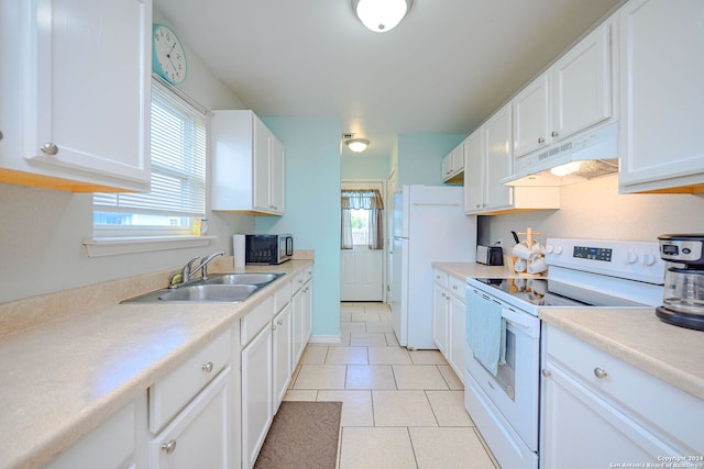 kitchen with white appliances, white cabinetry, and sink