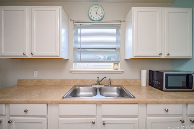 kitchen featuring sink and white cabinetry