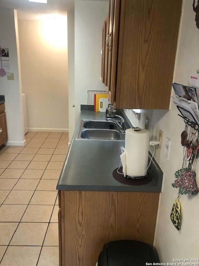 kitchen featuring sink and light tile patterned flooring