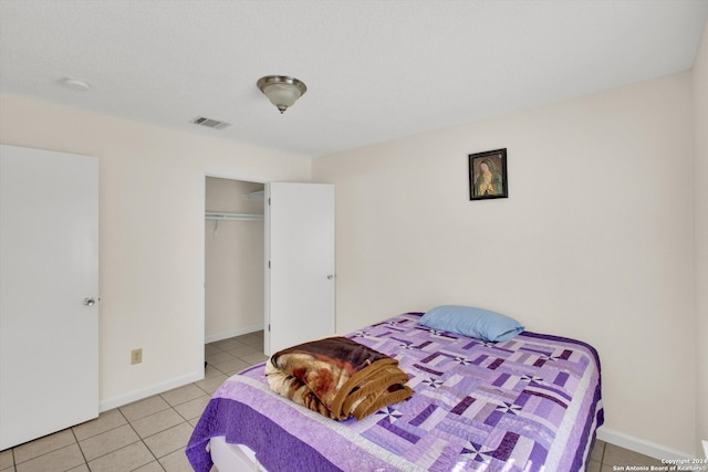 bedroom featuring light tile patterned flooring and a closet