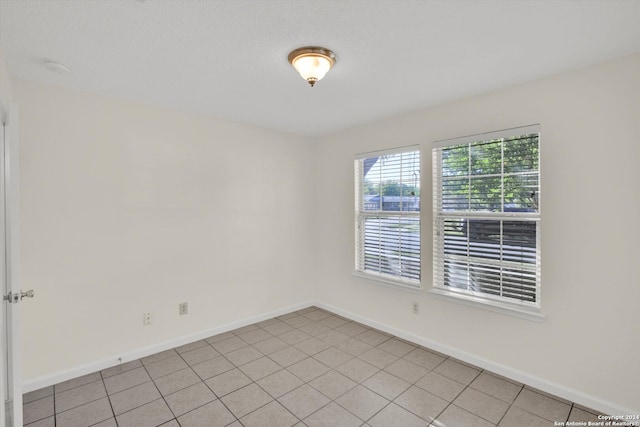 unfurnished room featuring light tile patterned floors